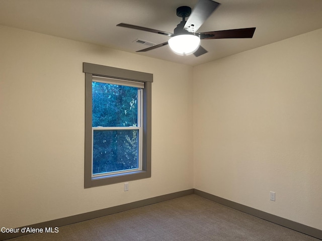 unfurnished room featuring a ceiling fan, visible vents, baseboards, and carpet flooring