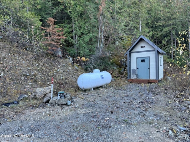 view of shed featuring a forest view