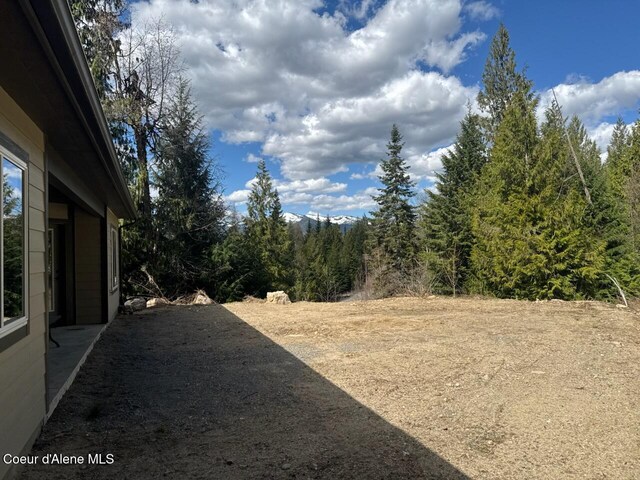 view of yard with a view of trees