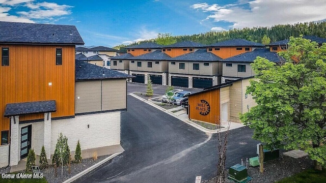 view of road with a residential view and community garages