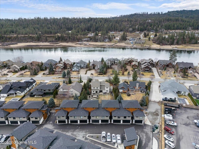 bird's eye view with a water view, a residential view, and a view of trees