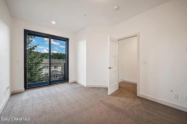 spare room with carpet flooring and baseboards