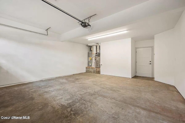 garage with water heater and a garage door opener