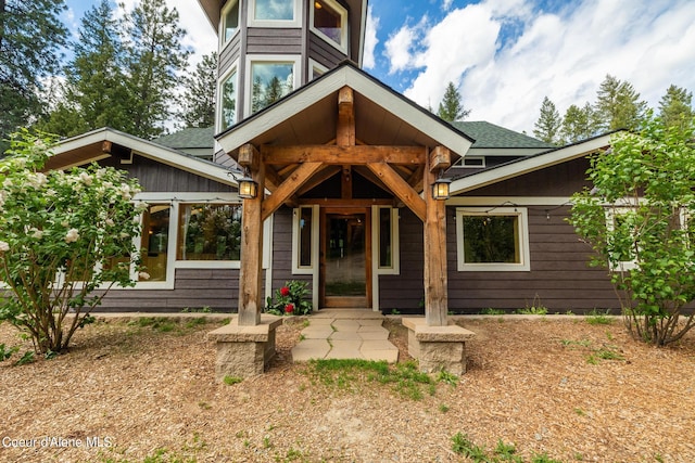 exterior space with roof with shingles