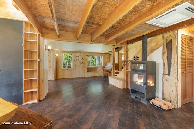 unfurnished living room with a wood stove and hardwood / wood-style flooring