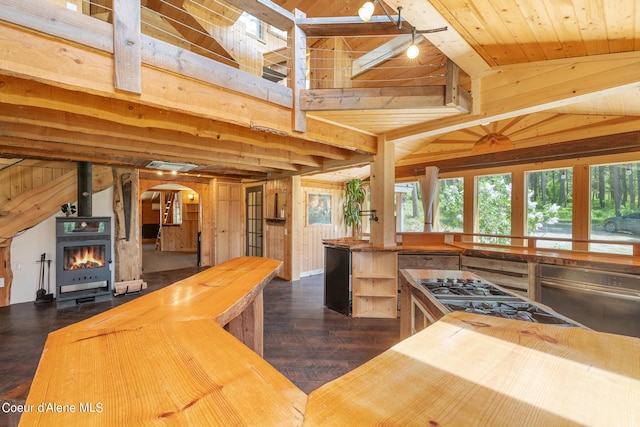 kitchen featuring wooden walls, range, wooden ceiling, wood counters, and vaulted ceiling