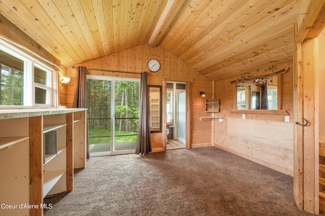 spare room featuring vaulted ceiling with beams, wood walls, carpet, and wood ceiling