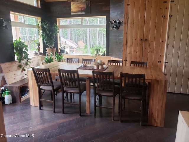 dining space featuring wooden walls