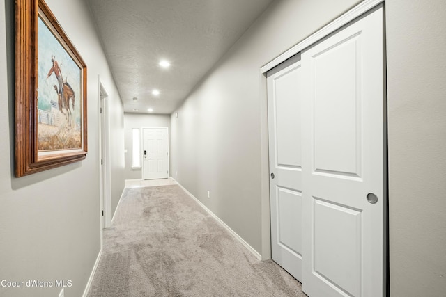 hall with carpet, baseboards, and recessed lighting