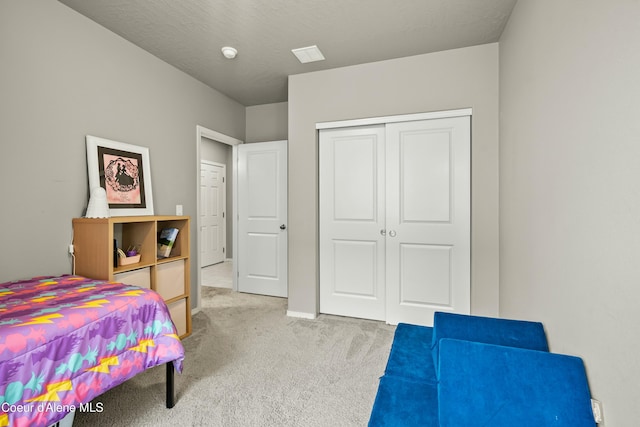 bedroom featuring baseboards, a closet, and light colored carpet