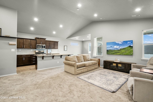 living area featuring recessed lighting, visible vents, light carpet, and baseboards