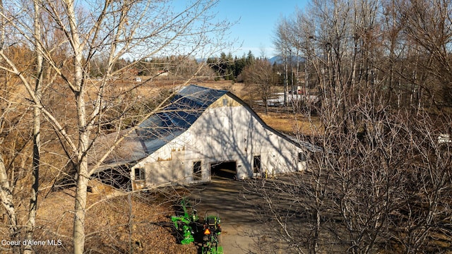 view of side of home featuring an outdoor structure and a barn