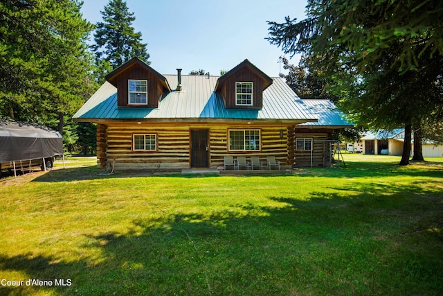 view of front of house featuring metal roof, a front lawn, and log siding