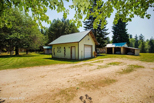 exterior space with driveway and an outbuilding