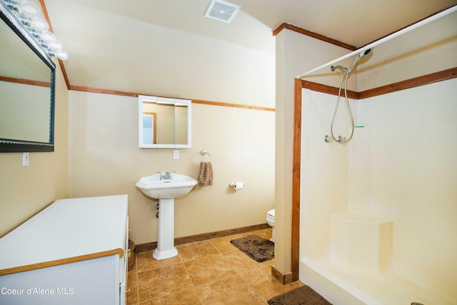 bathroom with a stall shower, baseboards, visible vents, and toilet