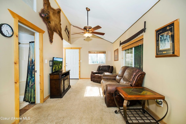 living room with lofted ceiling, ceiling fan, baseboards, and carpet flooring