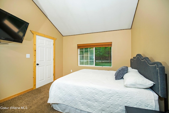 bedroom featuring baseboards, vaulted ceiling, and carpet flooring