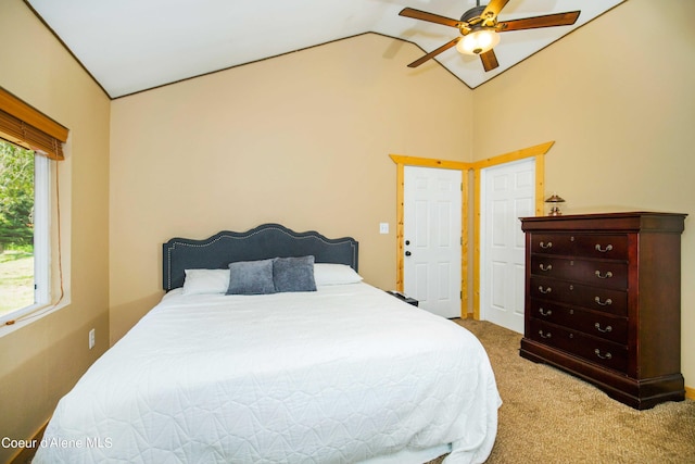 carpeted bedroom featuring ceiling fan and vaulted ceiling