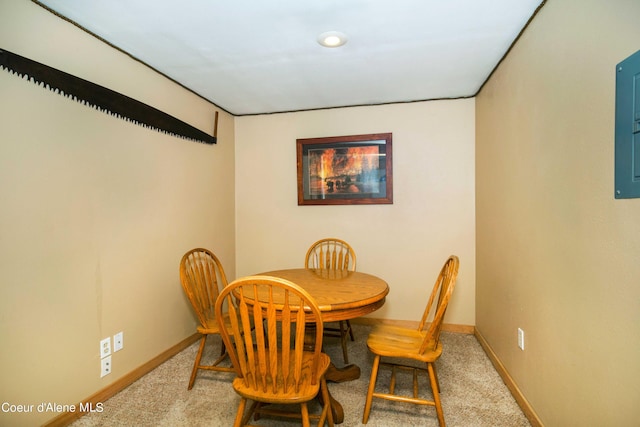 dining space featuring baseboards and carpet flooring