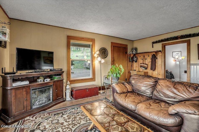 living room with a textured ceiling and wood finished floors