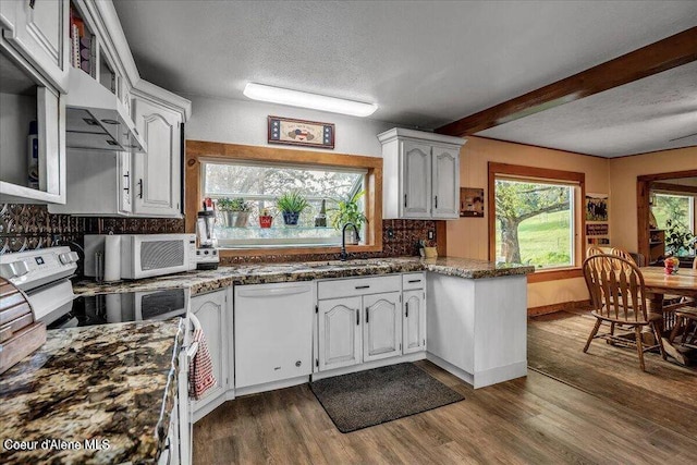 kitchen with a textured ceiling, electric range, dark wood-style flooring, a sink, and dishwasher