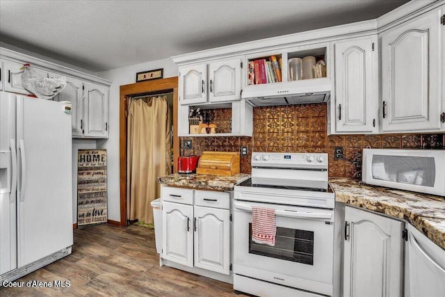 kitchen with under cabinet range hood, white appliances, wood finished floors, backsplash, and open shelves