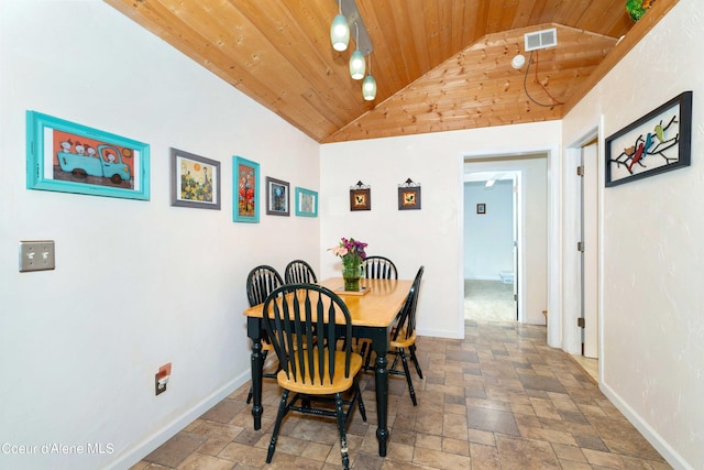 dining area featuring wooden ceiling, visible vents, stone finish flooring, and baseboards