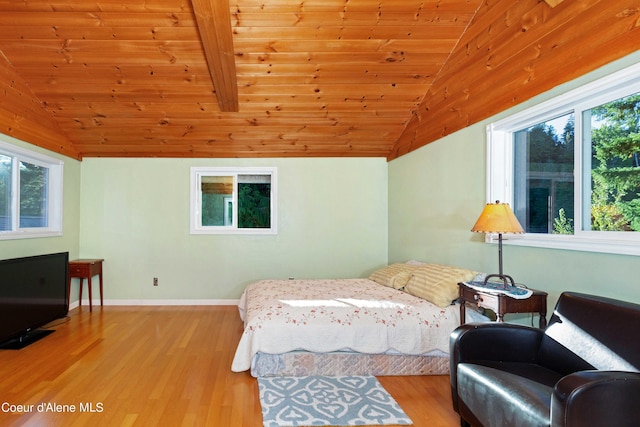 bedroom featuring lofted ceiling, wooden ceiling, wood finished floors, and baseboards