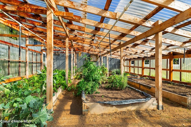 view of yard featuring fence and a vegetable garden