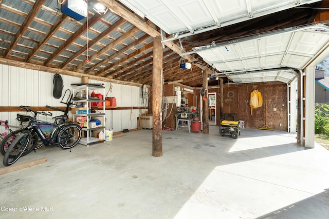 garage with metal wall and a garage door opener