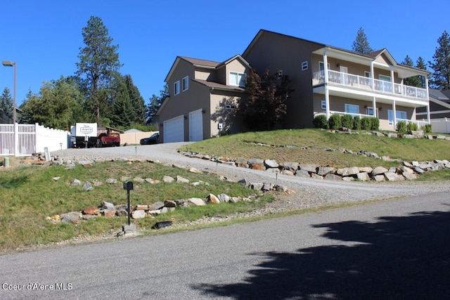 view of front of home featuring fence, driveway, and an attached garage