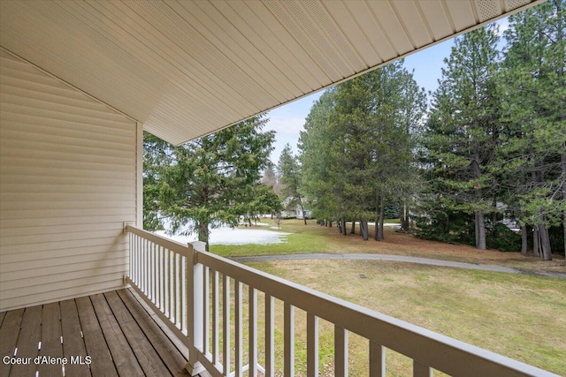 wooden terrace featuring a lawn