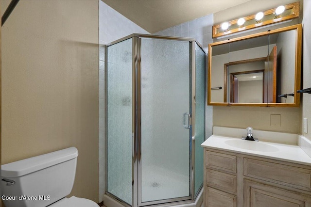 full bathroom with a stall shower, vanity, and toilet