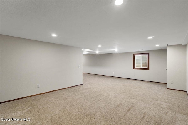 finished below grade area with carpet floors, baseboards, and recessed lighting