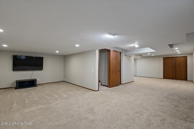 finished basement with recessed lighting and light colored carpet