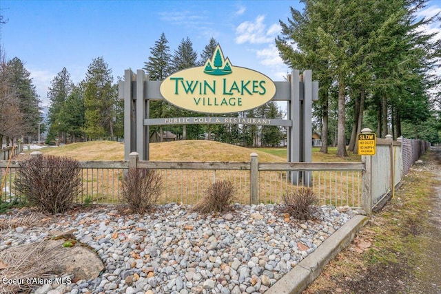 community / neighborhood sign with fence