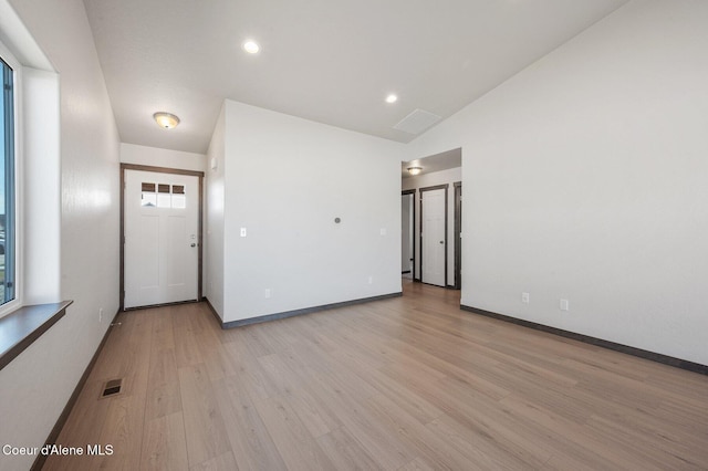 interior space with light wood-style floors, recessed lighting, visible vents, and baseboards