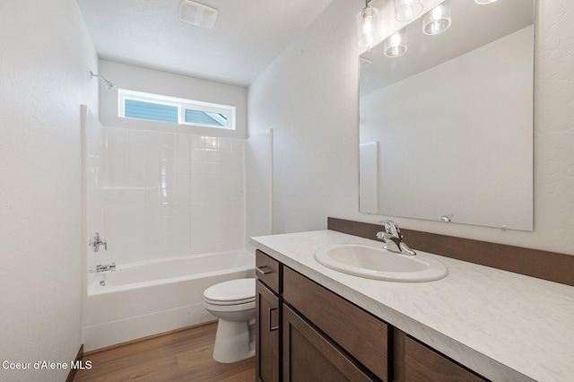 full bath featuring shower / bath combination, visible vents, toilet, wood finished floors, and vanity