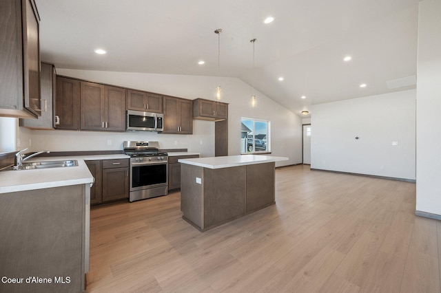 kitchen with a center island, light countertops, appliances with stainless steel finishes, a sink, and dark brown cabinetry