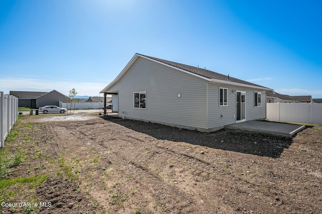 rear view of house with a patio area and fence