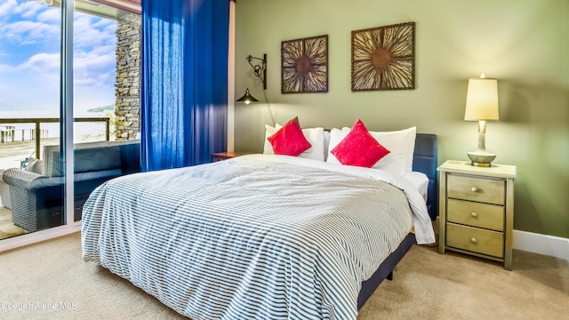 bedroom with carpet floors, access to outside, and baseboards