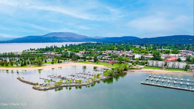 drone / aerial view featuring a water and mountain view