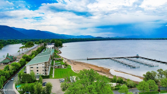 drone / aerial view featuring a water and mountain view