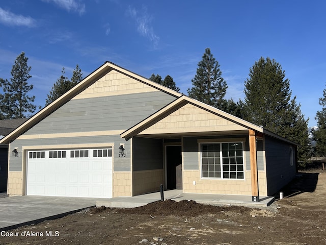 view of front of house with concrete driveway and an attached garage