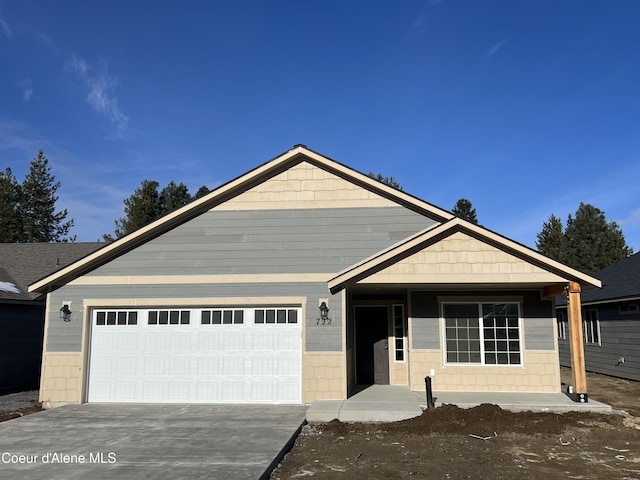 view of front of property with a garage and concrete driveway