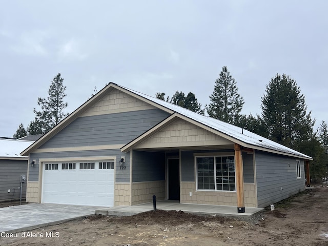 view of front of property featuring a garage and concrete driveway