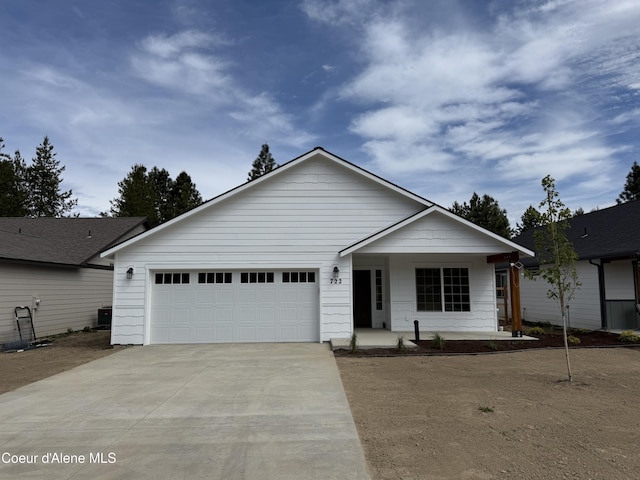 722 E Valley St S, Oldtown, ID 83822 - ranch-style home with concrete driveway, an attached garage, and covered porch
