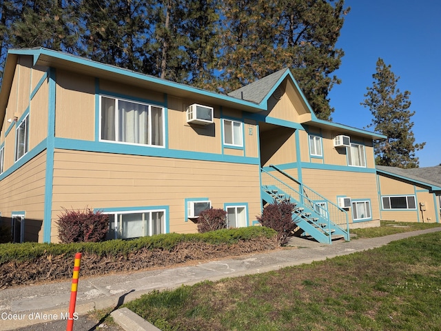 1810 Spokane St 1800, 1802, 1804, 1806, 1808, Post Falls, ID 83854 - view of side of property featuring an AC wall unit, stairway, and a wall mounted air conditioner