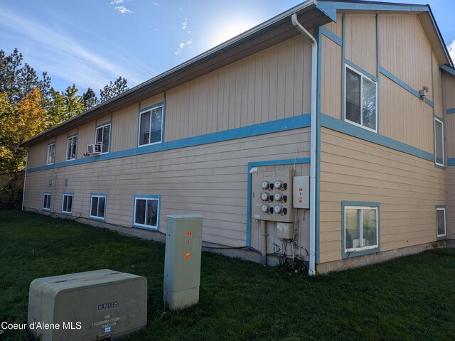 1810 Spokane St 1800, 1802, 1804, 1806, 1808, Post Falls, ID 83854 - view of side of home featuring cooling unit and a lawn