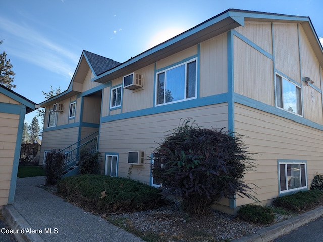 1810 Spokane St 1800, 1802, 1804, 1806, 1808, Post Falls, ID 83854 - view of home's exterior featuring stairs and a wall mounted air conditioner